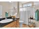Neutral bathroom with sink, toilet, and shower stall with white curtain and shelf at 10408 Georgetown Pl, Las Vegas, NV 89134
