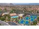 Aerial of the community center featuring tennis courts, a pool, a parking area, and surrounding landscaping at 10408 Georgetown Pl, Las Vegas, NV 89134