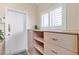 Bright hallway featuring a white door, closet with shelves and drawers, and a window with shutters at 10408 Georgetown Pl, Las Vegas, NV 89134