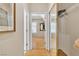 Hallway featuring hardwood floors, closet with sliding mirror doors, and doorways at 10408 Georgetown Pl, Las Vegas, NV 89134