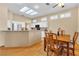 Modern kitchen with stainless steel appliances and adjacent dining area with ample seating at 10408 Georgetown Pl, Las Vegas, NV 89134