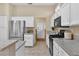 Well-equipped kitchen featuring granite countertops, stainless steel appliances, and white cabinetry at 10408 Georgetown Pl, Las Vegas, NV 89134