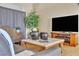 Cozy living room showcasing comfortable seating, a large television, and contemporary decor at 10408 Georgetown Pl, Las Vegas, NV 89134