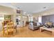 Bright and airy living room featuring wood floors, an open layout, and a dining area at 10408 Georgetown Pl, Las Vegas, NV 89134