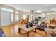 Open-concept living room with hardwood floors, dining area and a comfortable leather sofa at 10408 Georgetown Pl, Las Vegas, NV 89134