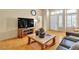 Living room with a flat screen TV, decorative table, and light hardwood flooring at 10408 Georgetown Pl, Las Vegas, NV 89134
