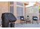 Outdoor patio featuring dark chairs, round table, and covered grill at 10408 Georgetown Pl, Las Vegas, NV 89134