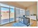Bright sunroom featuring sliding glass doors, hardwood floors, and a modern desk at 10408 Georgetown Pl, Las Vegas, NV 89134