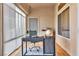 Bright sunroom featuring multiple windows, hardwood floors, and a modern desk at 10408 Georgetown Pl, Las Vegas, NV 89134