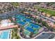 Aerial view of the tennis courts and recreation area amidst the surrounding neighborhood and mature trees at 10408 Georgetown Pl, Las Vegas, NV 89134