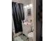 A bathroom featuring a vanity, a toilet, and a black and white shower curtain at 11 Magnesium St, Henderson, NV 89015