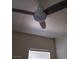 Modern ceiling fan with lighting fixture over room with window with blinds at 11 Magnesium St, Henderson, NV 89015