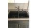 Functional double bowl kitchen sink with granite countertops and modern faucet fixture at 11 Magnesium St, Henderson, NV 89015