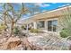 Landscaped backyard features mature foliage, a covered patio, and scenic views, perfect for outdoor living and entertaining at 11321 Golden Chestnut Pl, Las Vegas, NV 89135