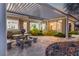 Inviting covered patio features a stone table, concrete floors, and desert landscaping at 11321 Golden Chestnut Pl, Las Vegas, NV 89135