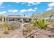 Spacious backyard features mature landscaping, a covered patio, and beautiful desert views, ideal for relaxation and entertaining at 11321 Golden Chestnut Pl, Las Vegas, NV 89135