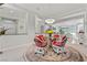 Elegant dining area with a unique chandelier and backyard views for a bright space at 11321 Golden Chestnut Pl, Las Vegas, NV 89135