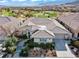 Stunning exterior elevation showcasing the desert landscaping and beautiful tile roof at 11321 Golden Chestnut Pl, Las Vegas, NV 89135