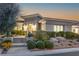 Desert landscaping surrounds the front entrance of this stunning home near sunset at 11321 Golden Chestnut Pl, Las Vegas, NV 89135