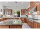 Well-appointed kitchen with wood cabinets, granite countertops, and stainless steel range at 11321 Golden Chestnut Pl, Las Vegas, NV 89135