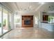 Bright living room with large windows, sliding doors, and built-in entertainment center at 11321 Golden Chestnut Pl, Las Vegas, NV 89135