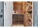 Custom wine cellar with ample storage for wine bottles and bar accessories at 11321 Golden Chestnut Pl, Las Vegas, NV 89135