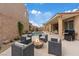 Inviting backyard with cozy seating around a fire pit and a view of the swimming pool and covered patio at 1269 Olivia Pkwy, Henderson, NV 89011