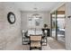 Bright dining room featuring stone accent wall, designer lighting, and sliding door to the backyard pool at 1269 Olivia Pkwy, Henderson, NV 89011