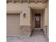 Inviting front entryway with stone accents, a decorative wreath and brick paved driveway at 1269 Olivia Pkwy, Henderson, NV 89011