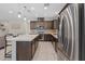 Gourmet kitchen featuring stainless steel appliances, granite counters and dark wood cabinets at 1269 Olivia Pkwy, Henderson, NV 89011