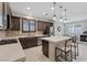 Spacious kitchen featuring dark cabinets, a center island, and stainless steel appliances at 1269 Olivia Pkwy, Henderson, NV 89011