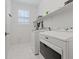 Bright laundry room featuring modern washer and dryer and ample shelving at 1269 Olivia Pkwy, Henderson, NV 89011