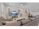 Spacious living room features a large gray sectional sofa, modern ceiling fan and custom built-in shelving at 1269 Olivia Pkwy, Henderson, NV 89011