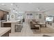 Open-concept living space with a kitchen island, dining area, and comfortable living room at 1269 Olivia Pkwy, Henderson, NV 89011