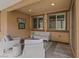 Inviting covered patio featuring neutral furniture, area rug, and charming decor, perfect for relaxation at 1269 Olivia Pkwy, Henderson, NV 89011