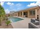 Picturesque backyard featuring a refreshing swimming pool, covered patio, and comfortable seating area at 1269 Olivia Pkwy, Henderson, NV 89011