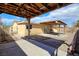 Open backyard with a covered patio area, showing the exterior of the home with access doors and a fenced side yard at 1413 Culley St, Las Vegas, NV 89110