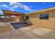 Expansive backyard showing the home's exterior, a covered patio, and a view of the clear blue sky at 1413 Culley St, Las Vegas, NV 89110