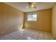 Standard bedroom featuring tile flooring, neutral walls, and a window with natural light at 1413 Culley St, Las Vegas, NV 89110