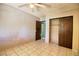 Neutral bedroom featuring tiled floors, ceiling fan, closet and en-suite at 1413 Culley St, Las Vegas, NV 89110