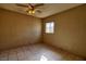 Standard bedroom with overhead fan and window, neutral walls and tile flooring at 1413 Culley St, Las Vegas, NV 89110
