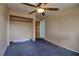 Bedroom featuring neutral walls, blue carpeting, closet, and an open doorway at 1413 Culley St, Las Vegas, NV 89110