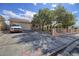 Charming single-story home featuring a large driveway, desert landscaping, and a gated front yard at 1413 Culley St, Las Vegas, NV 89110