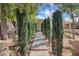 Stone walkway and lush landscaping lead to the front door, creating a serene entrance at 1413 Culley St, Las Vegas, NV 89110