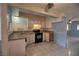 Functional kitchen featuring a black oven, tile flooring, granite countertops, and ample cabinet space at 1413 Culley St, Las Vegas, NV 89110