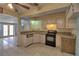 Functional kitchen with white cabinets and tiled flooring, adjacent to bright living spaces at 1413 Culley St, Las Vegas, NV 89110