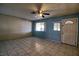 A bright living room with tiled floors, a ceiling fan, and ample natural light at 1413 Culley St, Las Vegas, NV 89110