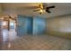Spacious living room with tile flooring, ceiling fan, and seamless flow to other rooms at 1413 Culley St, Las Vegas, NV 89110