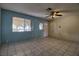 Inviting living room featuring tiled floors, ceiling fan, and view to covered porch at 1413 Culley St, Las Vegas, NV 89110