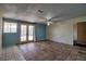 Living room with tile flooring, ceiling fan, and access to the backyard through French doors at 1413 Culley St, Las Vegas, NV 89110